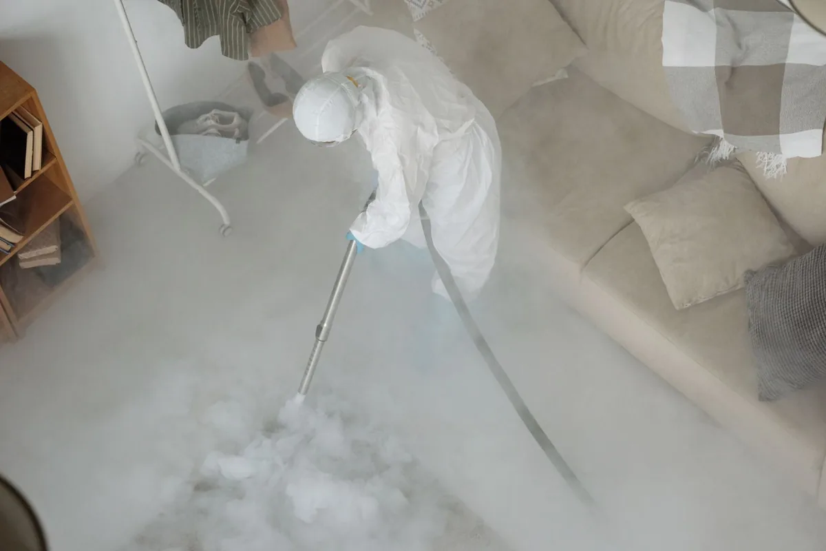Biohazard cleanup technician in protective equipment, Wallingford Center, CT